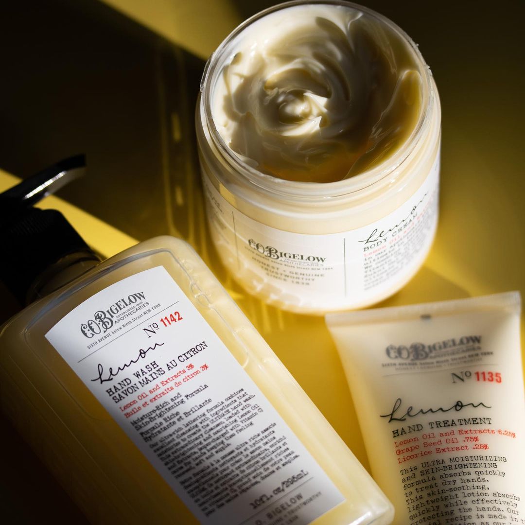 Co-bgclw skincare products including a jar, bottle, and tube on a yellow background