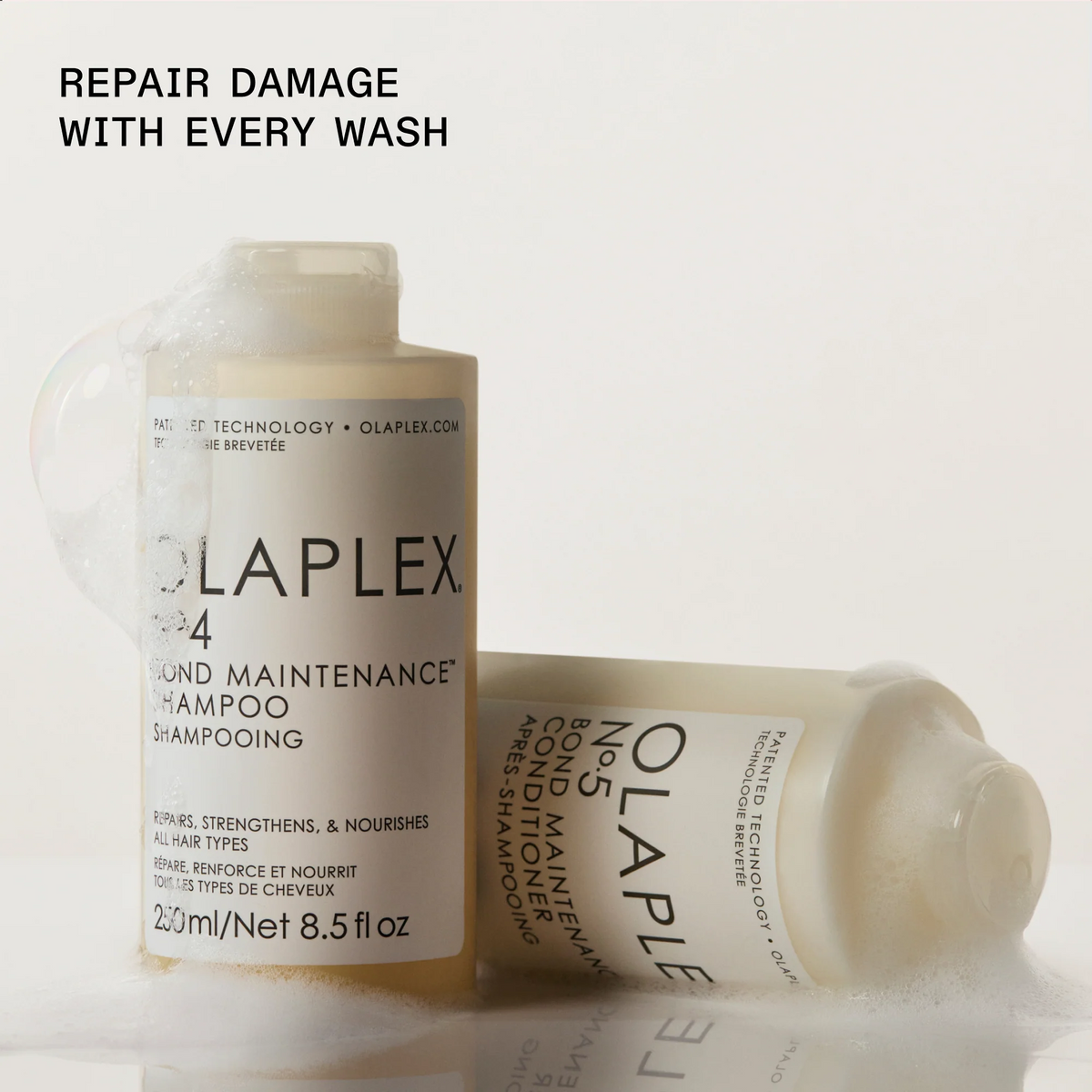 Two Olaplex hair care bottles on a clean white background with foam around them. One upright bottle reads '4 Bond Maintenance Shampoo' and the other horizontal bottle reads '4 Bond Maintenance Conditioner.