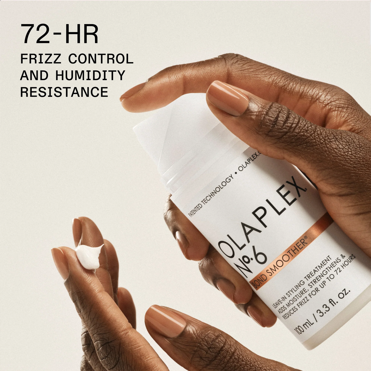 Olaplex hair treatment product held by a hand with text about frizz control and humidity resistance.