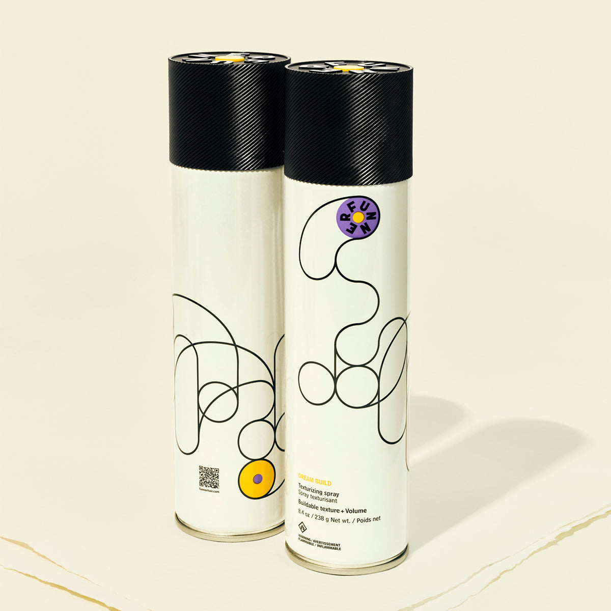 Two cylindrical products with black lids on a beige background