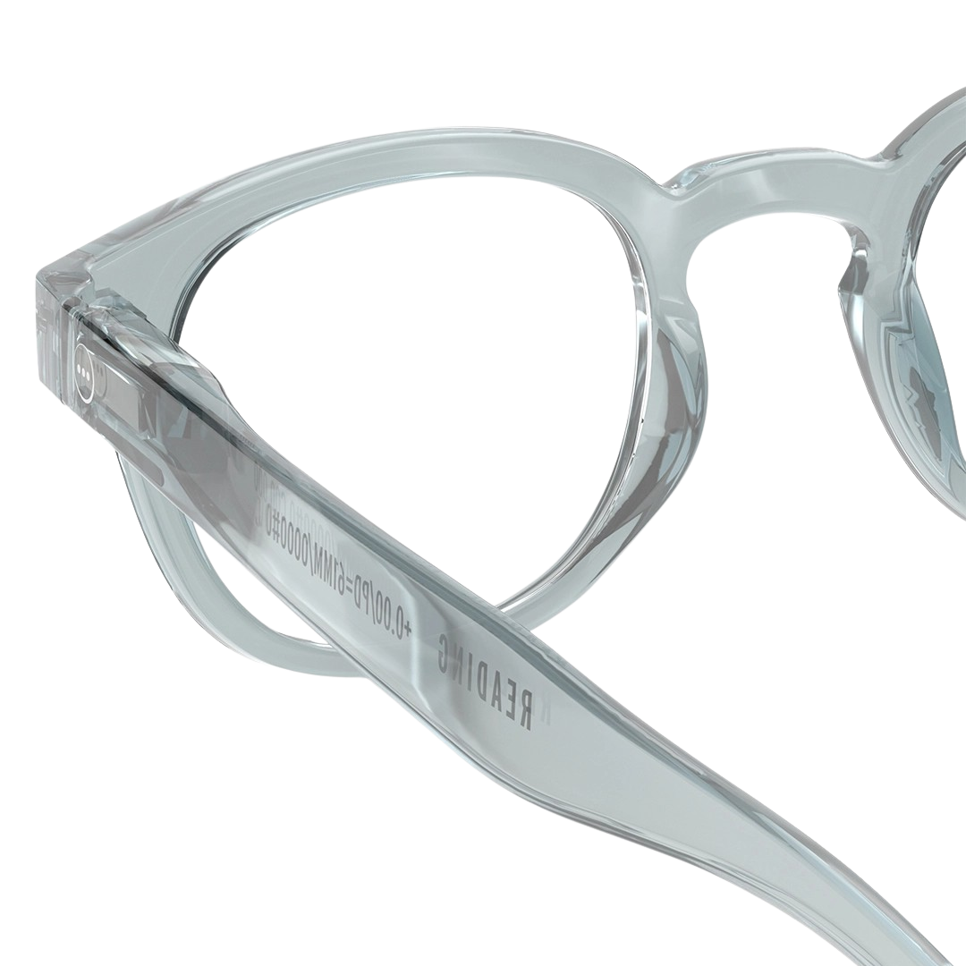 Close-up of "Frozen Blue" eyeglasses with brand name on a white background