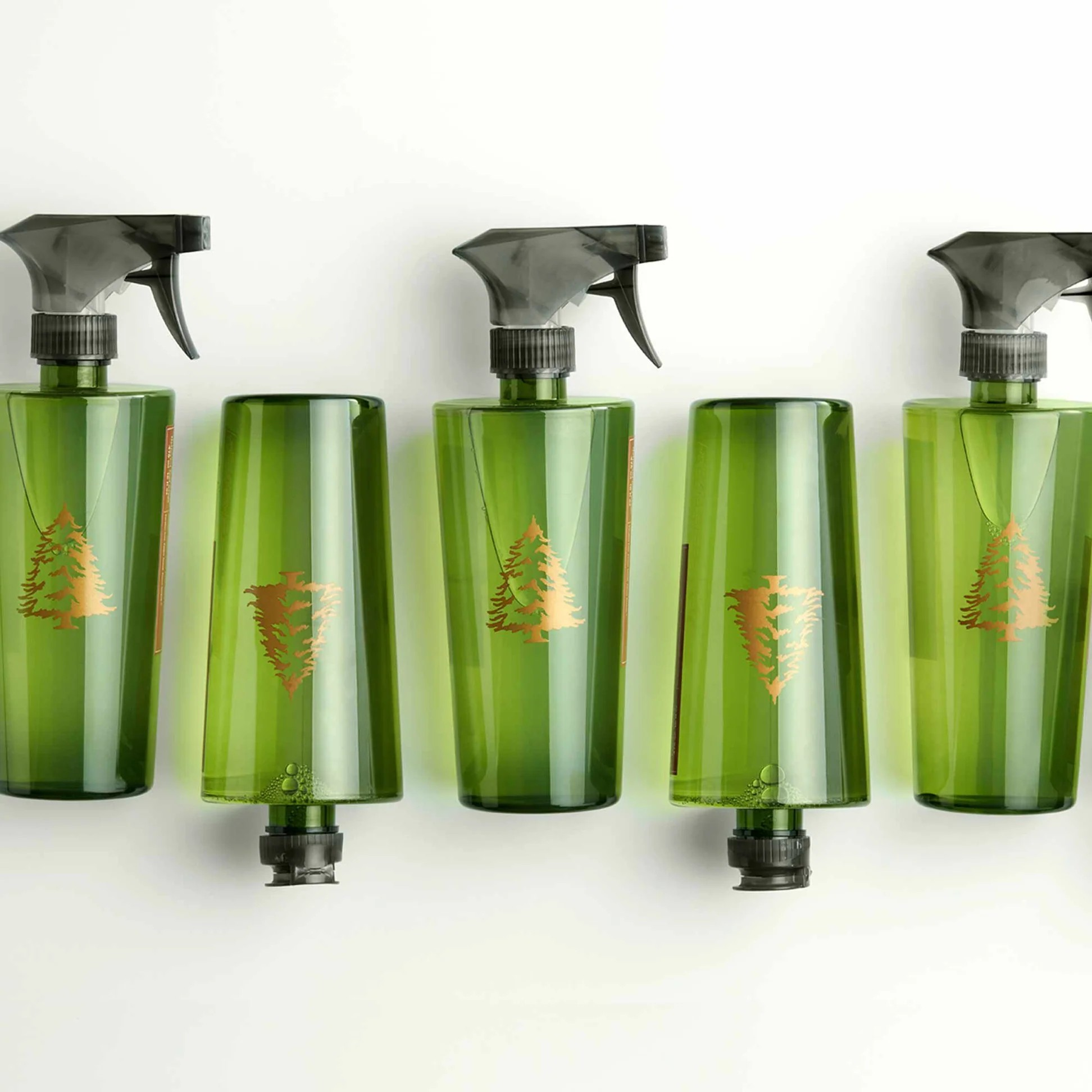 Five green spray bottles with a logo on a white background