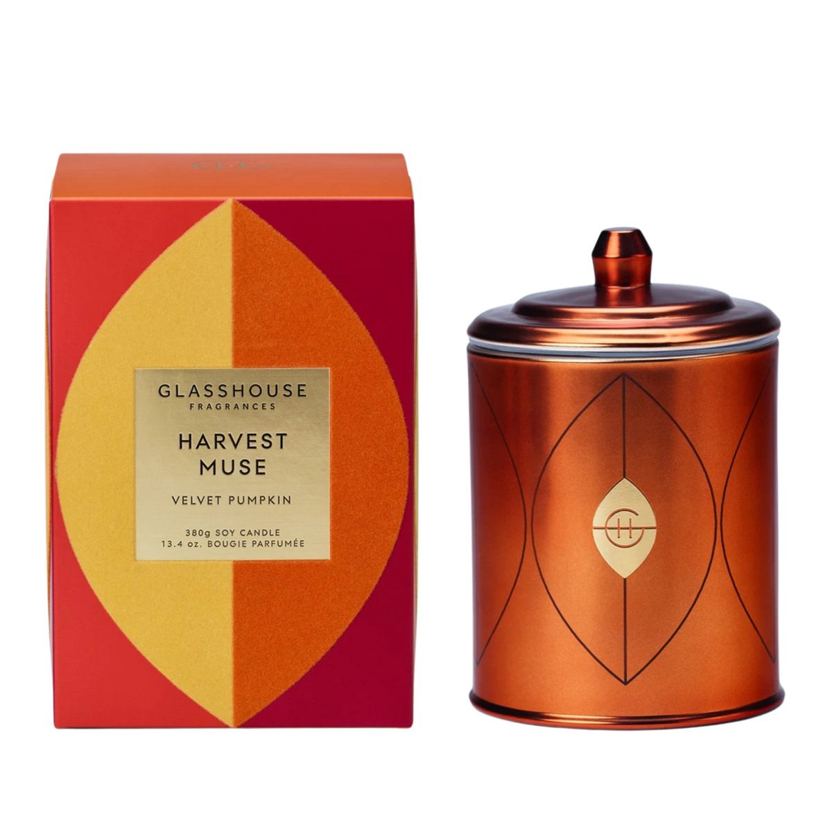 A 30g soy candle in a metallic copper-colored tin with a lid, shown next to its red and orange geometric packaging box. The box features a gold label for 'GLASSHOUSE FRAGRANCIES' and 'HARVEST MUSE VELVET PUMPKIN'.