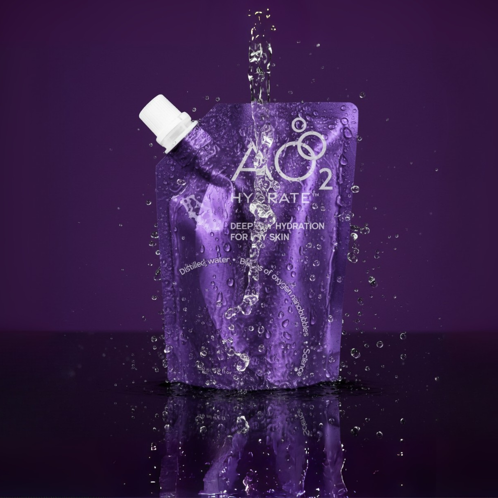 Purple packaging of AO2 Hydrate with water being poured onto it against a purple background