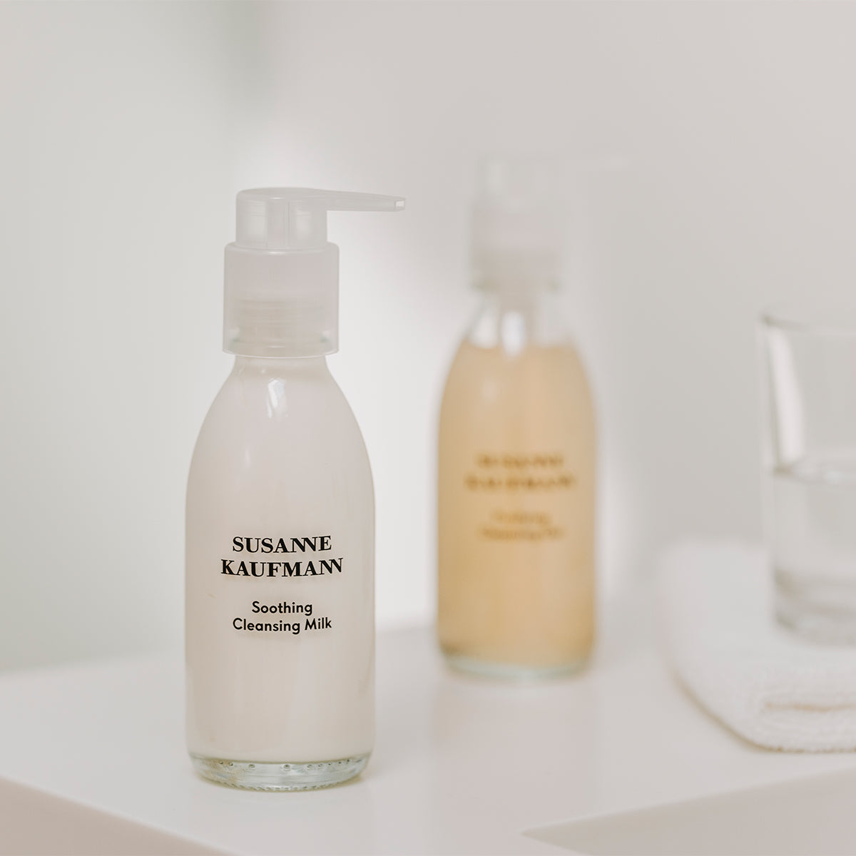 Bottle of Susanne Kaufmann Soothing Cleansing Milk on a white surface