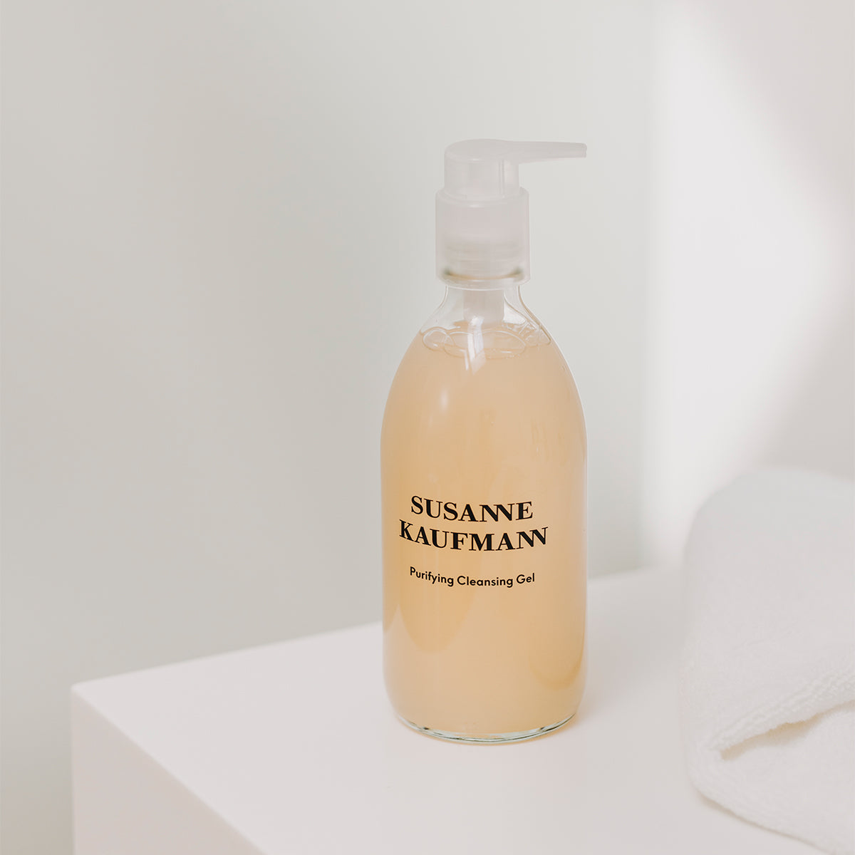 Bottle of Susanne Kaufmann cleansing gel on a white surface with a light gray background