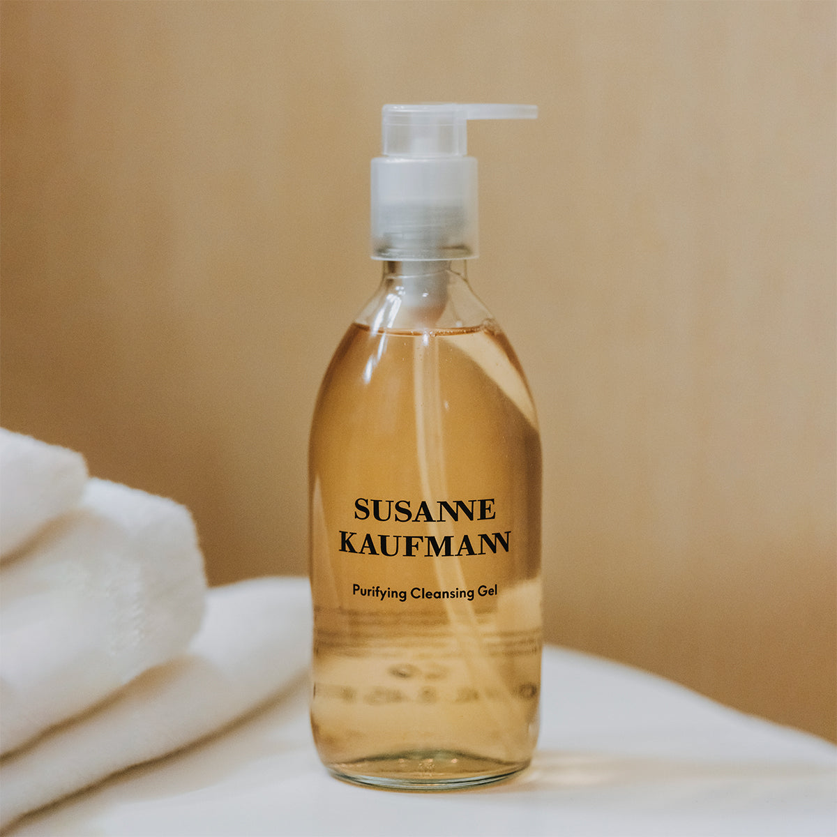 Bottle of Susanne Kaufmann Purifying Cleansing Gel on a beige background