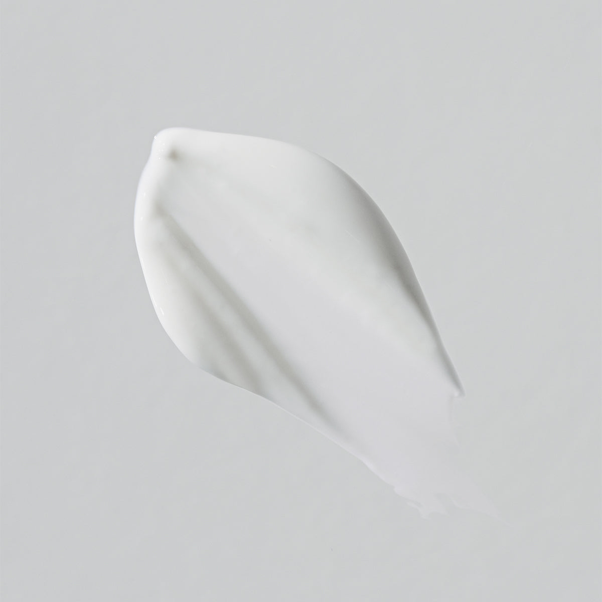 Close-up of a white product swatch on a light gray background