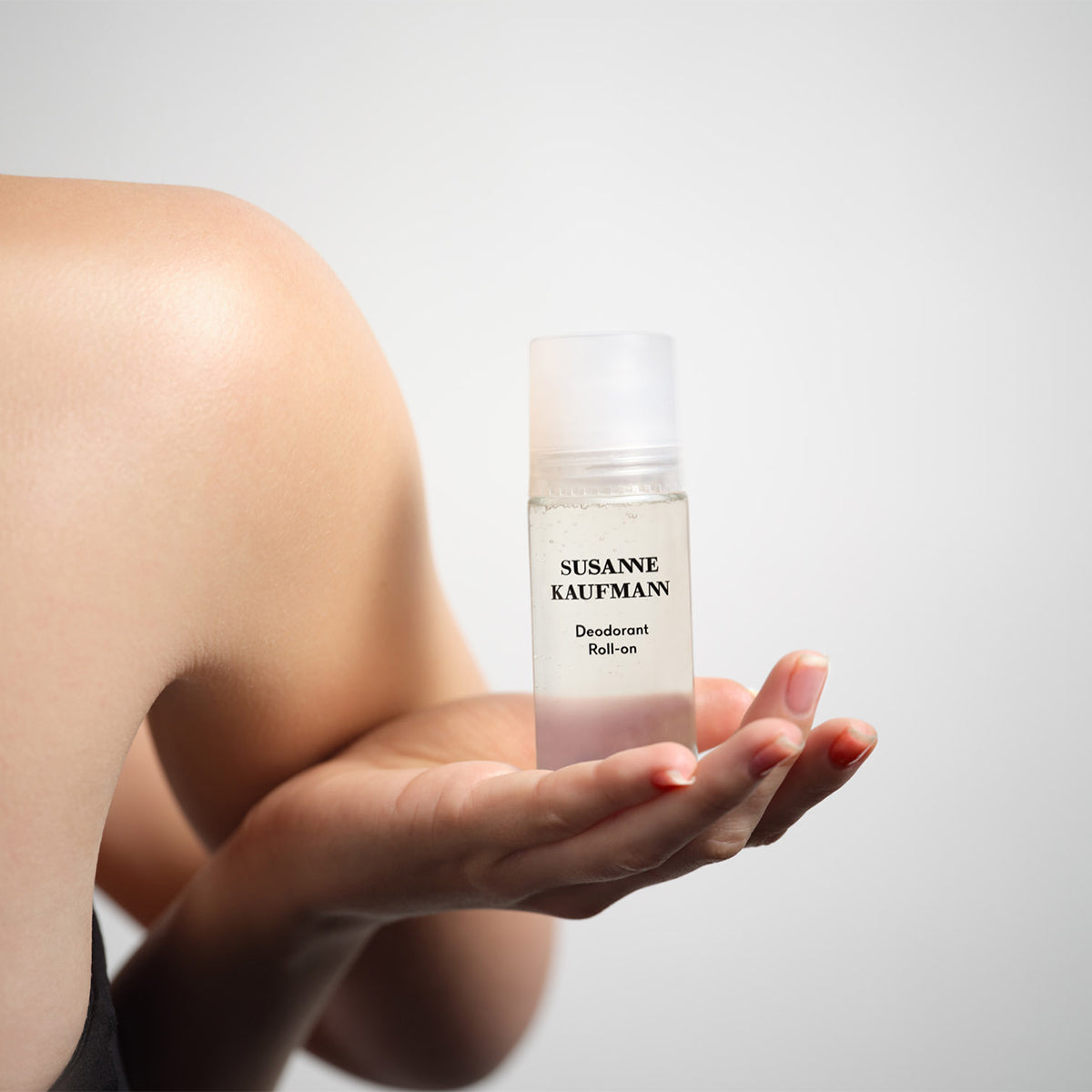 Hand holding Susanne Kaufmann Deodorant Roll-on