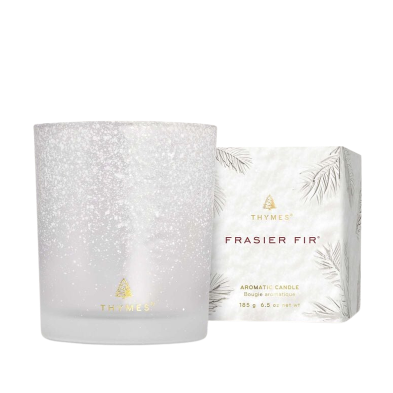 Fragranced candle and packaging with 'Thymes Frasier Fir' branding on a white background