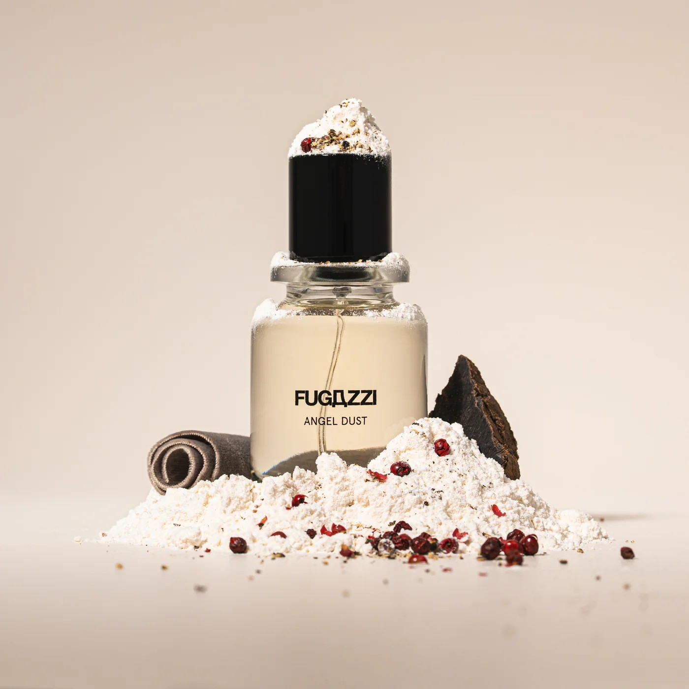 Fugazzi Angel Dust bottle with powder and red peppercorns around it.