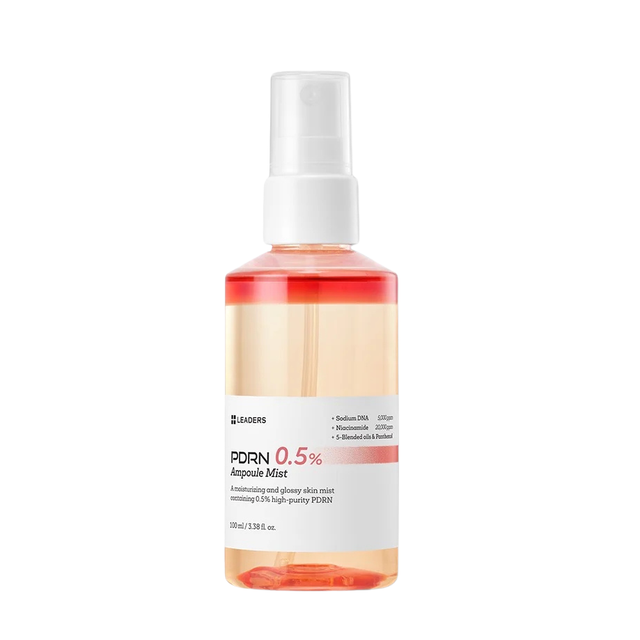 A 200ml spray bottle of LEADERS PDRN 0.5% Ampoule Mist, featuring a white spray nozzle and a white label with pink and black text, containing a peach-colored liquid with a red translucent cap, set against a plain white background.