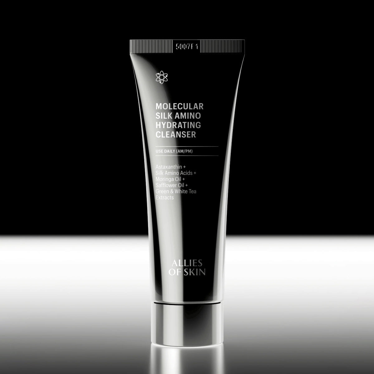 Skincare cleanser tube labeled 'Molecular Silk Amino Hydrating Cleanser' by 'Allies of Skin' on a reflective surface with black background.