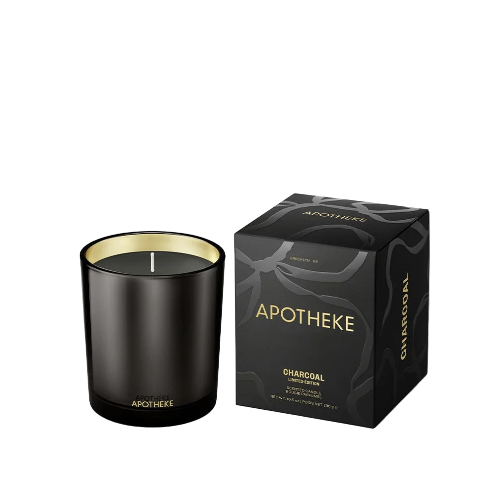 Black candle with gold interior and matching packaging box labeled 'Apotheke' on a white background