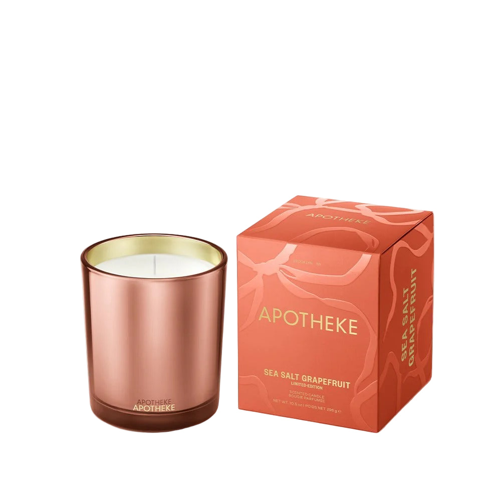 Rose gold candle with 'Apotheke' packaging on a white background