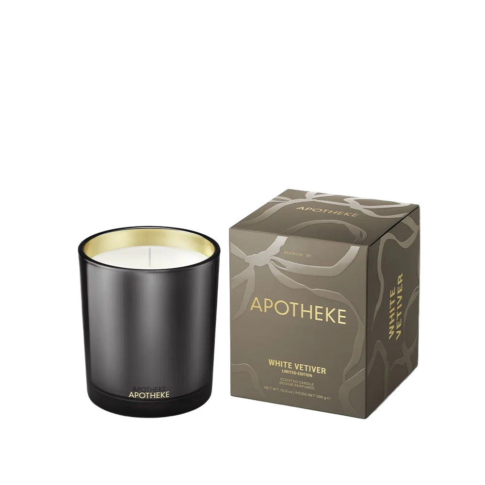 Black candle with gold interior and matching box labeled 'Apotheke White Vetiver' on a white background