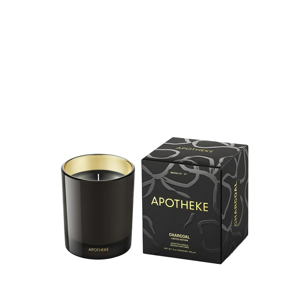 Black candle with gold interior and matching packaging box labeled 'Apotheke' on a white background