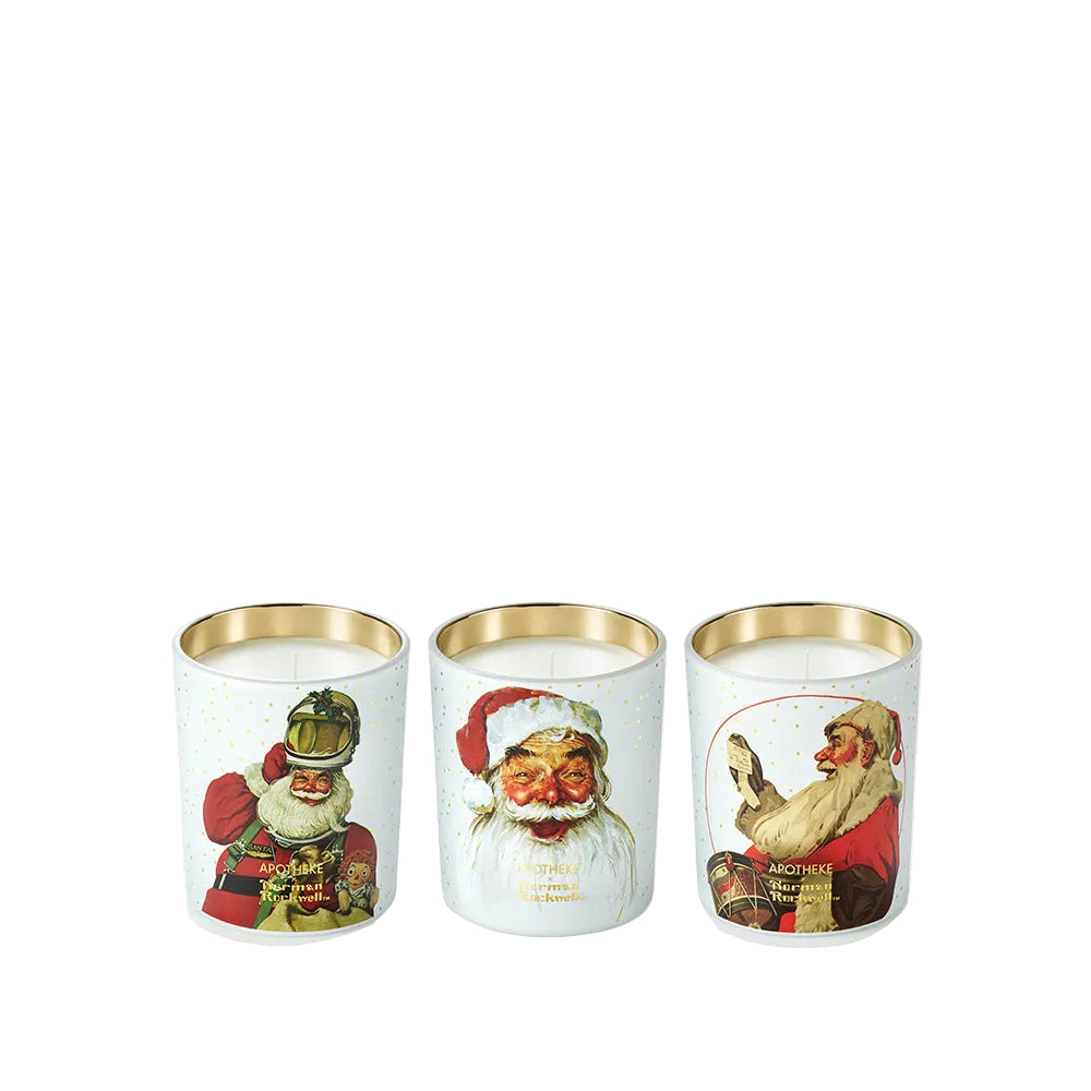 Three white holiday-themed candles in clear glass jars with gold rims, featuring vintage Santa Claus illustrations on a clean white background.