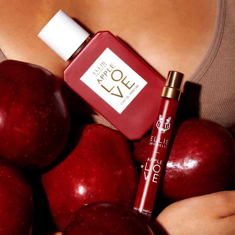 Woman holding Ellis Brooklyn Apple Love Eau de Parfum and apples