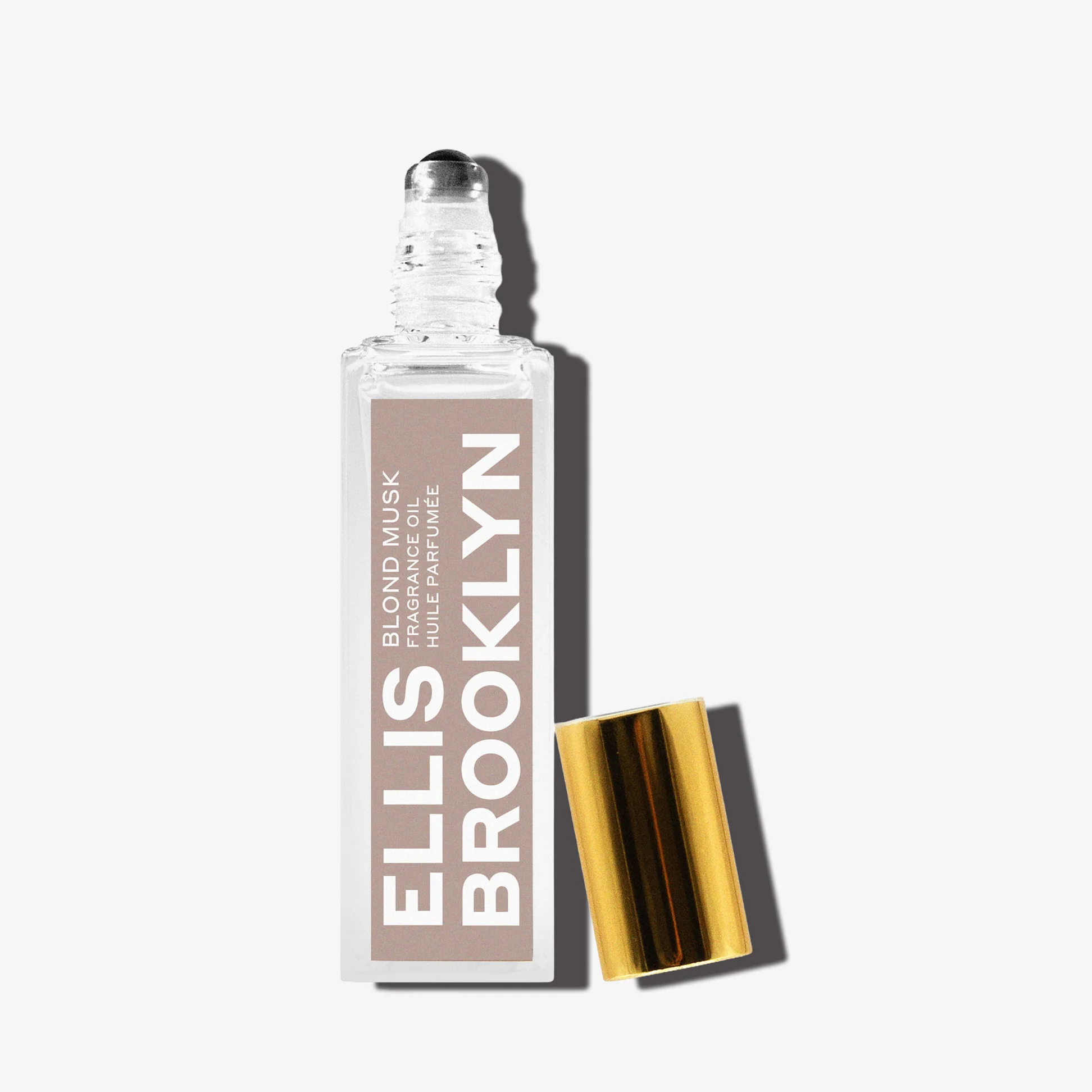 Ellis Brooklyn Blond Musk bottle with dramatic lighting on a white background