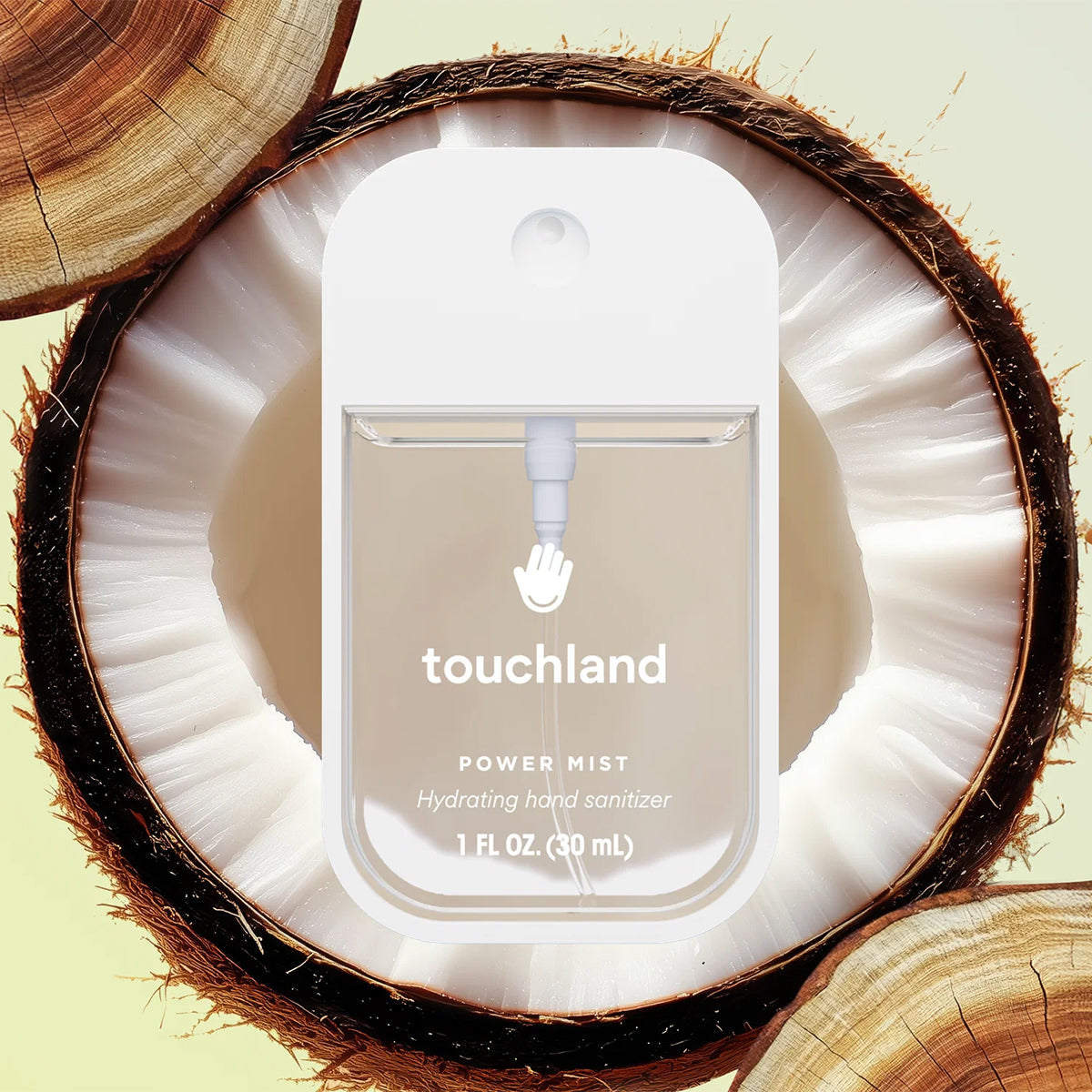 Touchland Power Mist Hydrating Hand Sanitizer - Beach Coco inside a coconut shell on a light green background