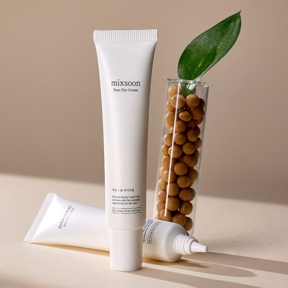 mixsoon Bean Eye Cream tube presented with beans in a test tube in a neutral beige environment