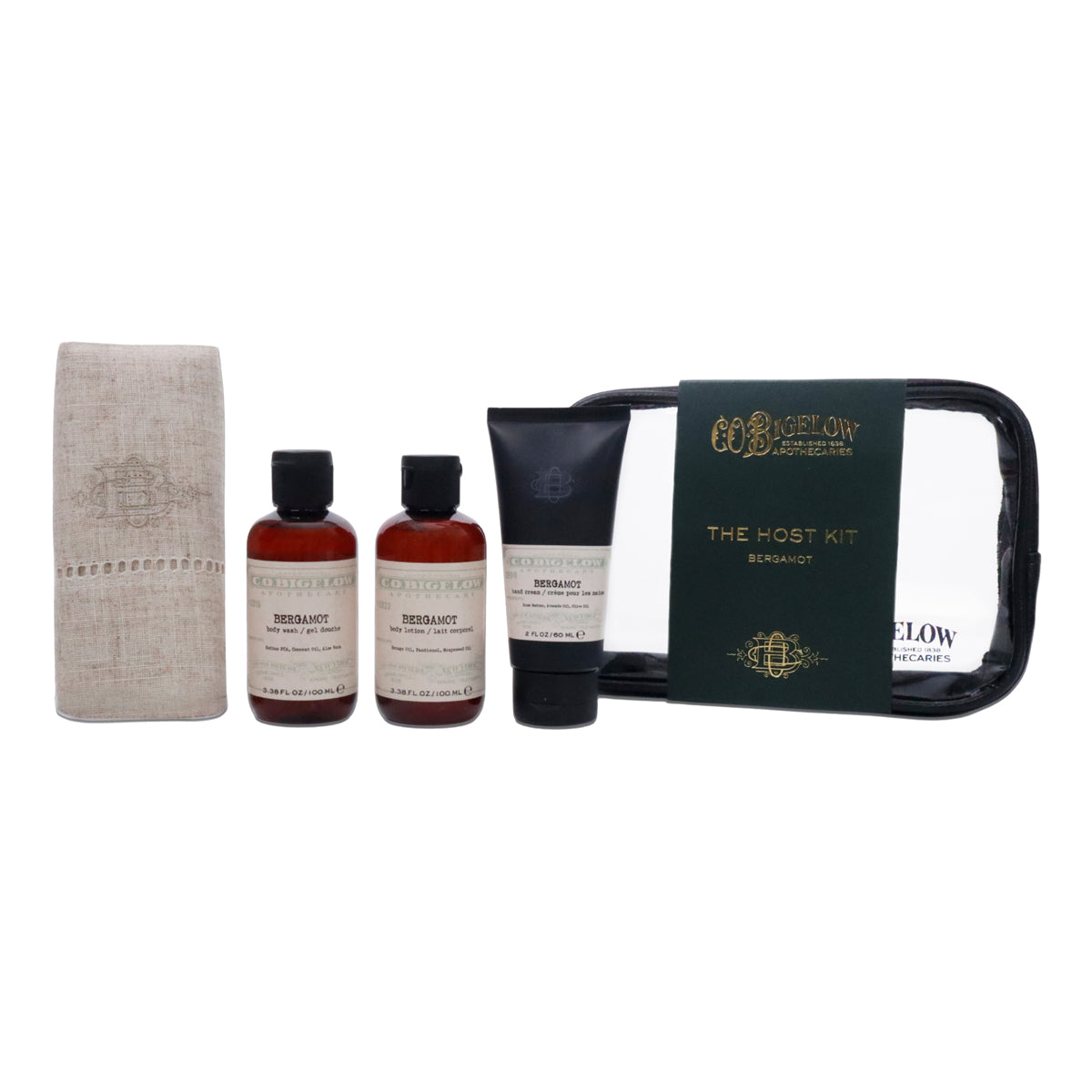 C.O. Bigelow 'The Host Kit' set containing a beige linen towel, two amber bottles of Terraiux shower gel, a black tube of Terraiux body wash, and a black zippered pouch with a dark green label.