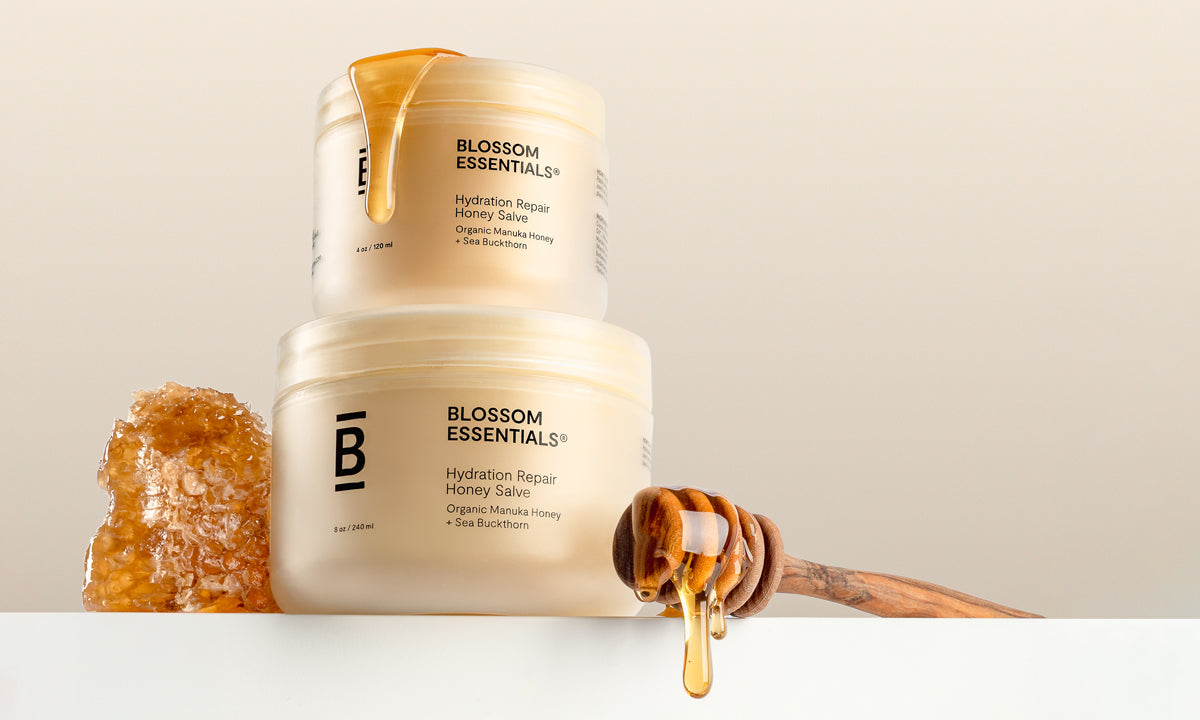 Two jars of Blossom Essentials cream with honeycomb and honey on a light background