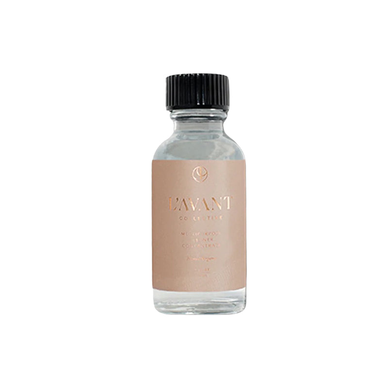 Clear bottle with black cap and beige label on a white background