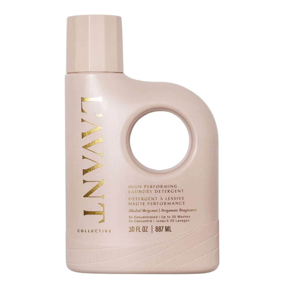 Pink bottle of laundry detergent with gold text on a white background