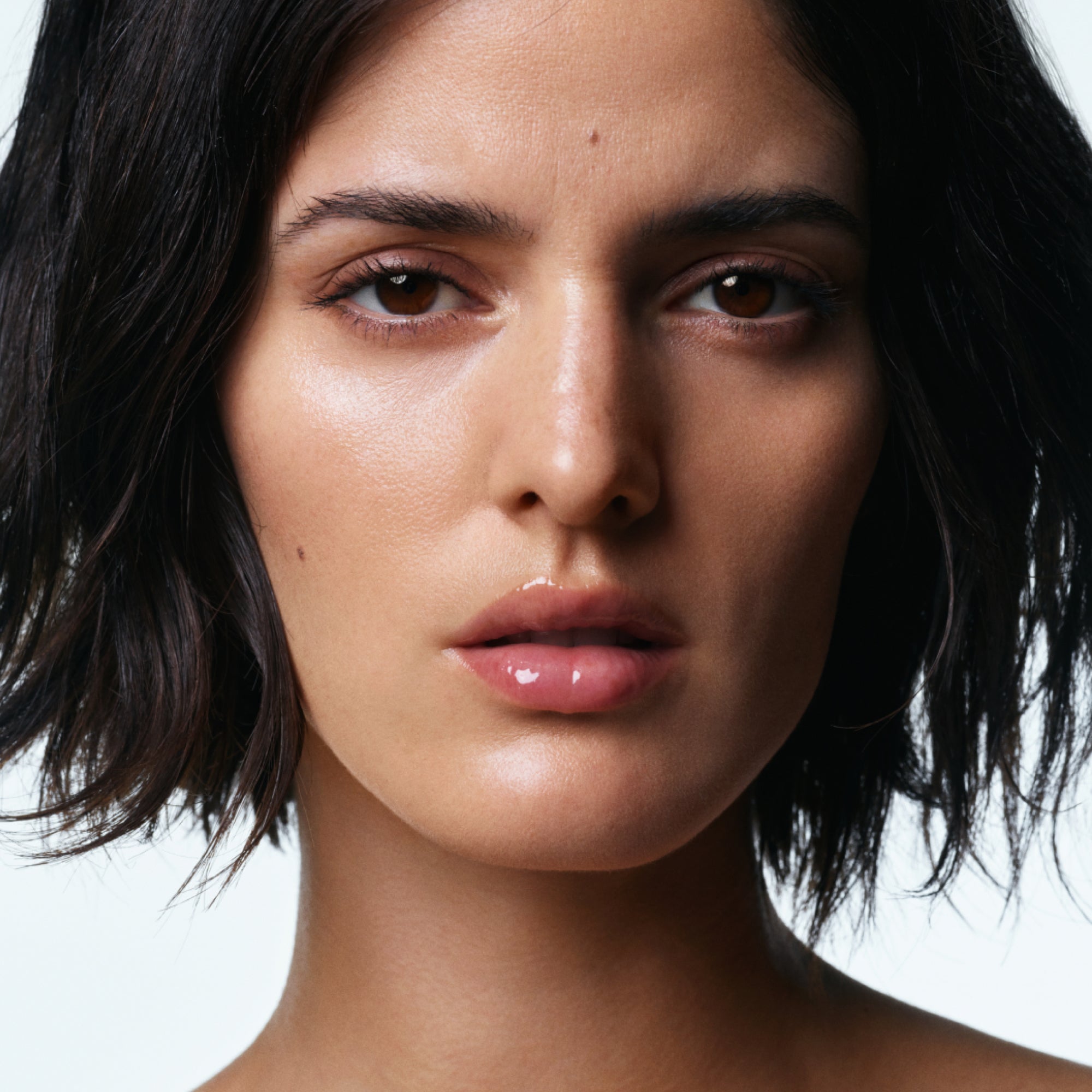 Model wearing U Beauty's The PLASMA Lip Compound in shade Universal.