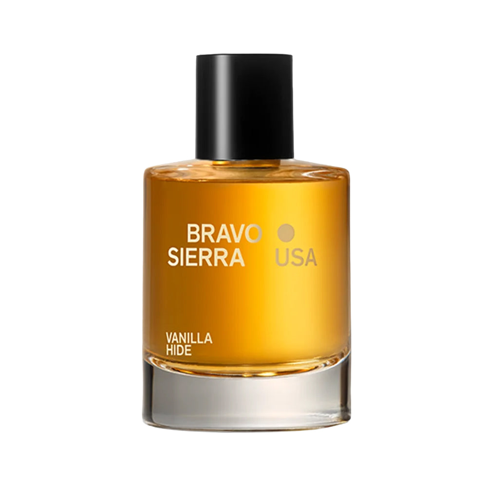 A bottle of Bravo Sierra Vanilla Hide - Eau de Parfum with amber-colored liquid, a black cap, and gold lettering on a clean white background.
