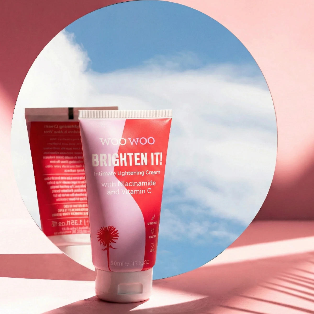 Woo Woo Brighten It! skincare cream tube with a pink background