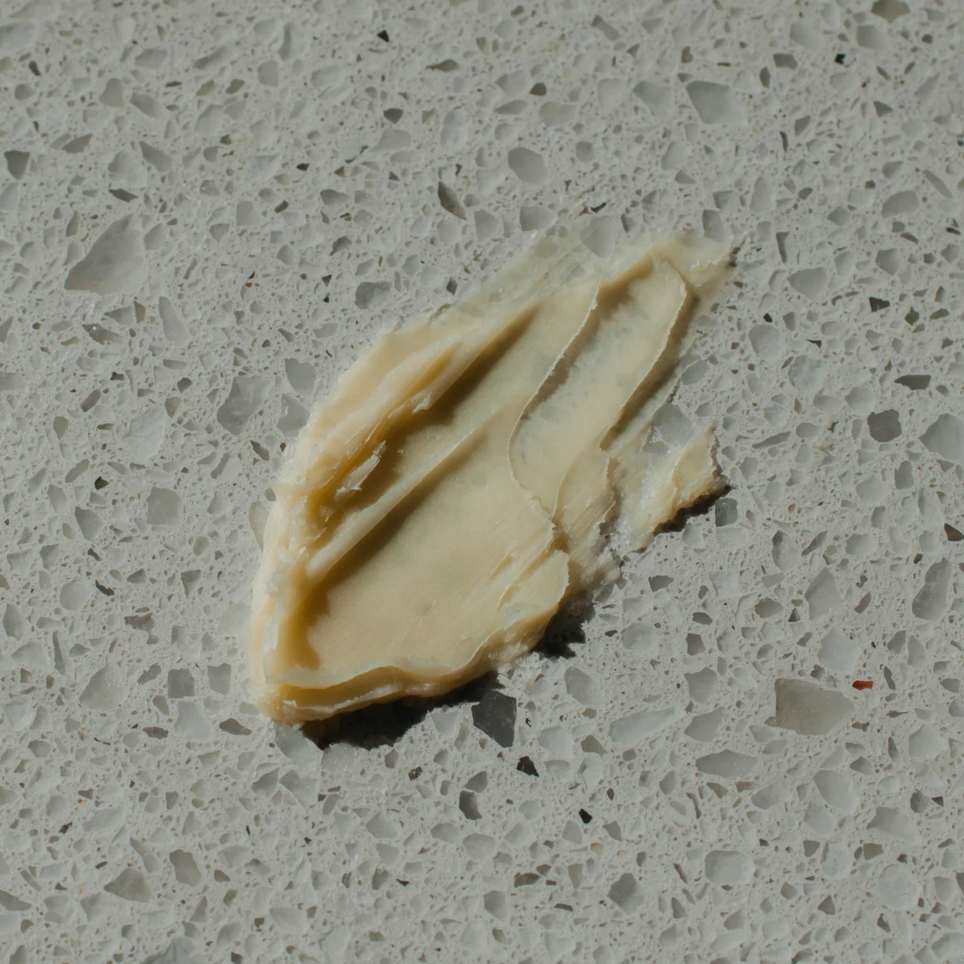 Swatch of Brooklyn Grooming's Matte Cream Pomade on a marble surface.