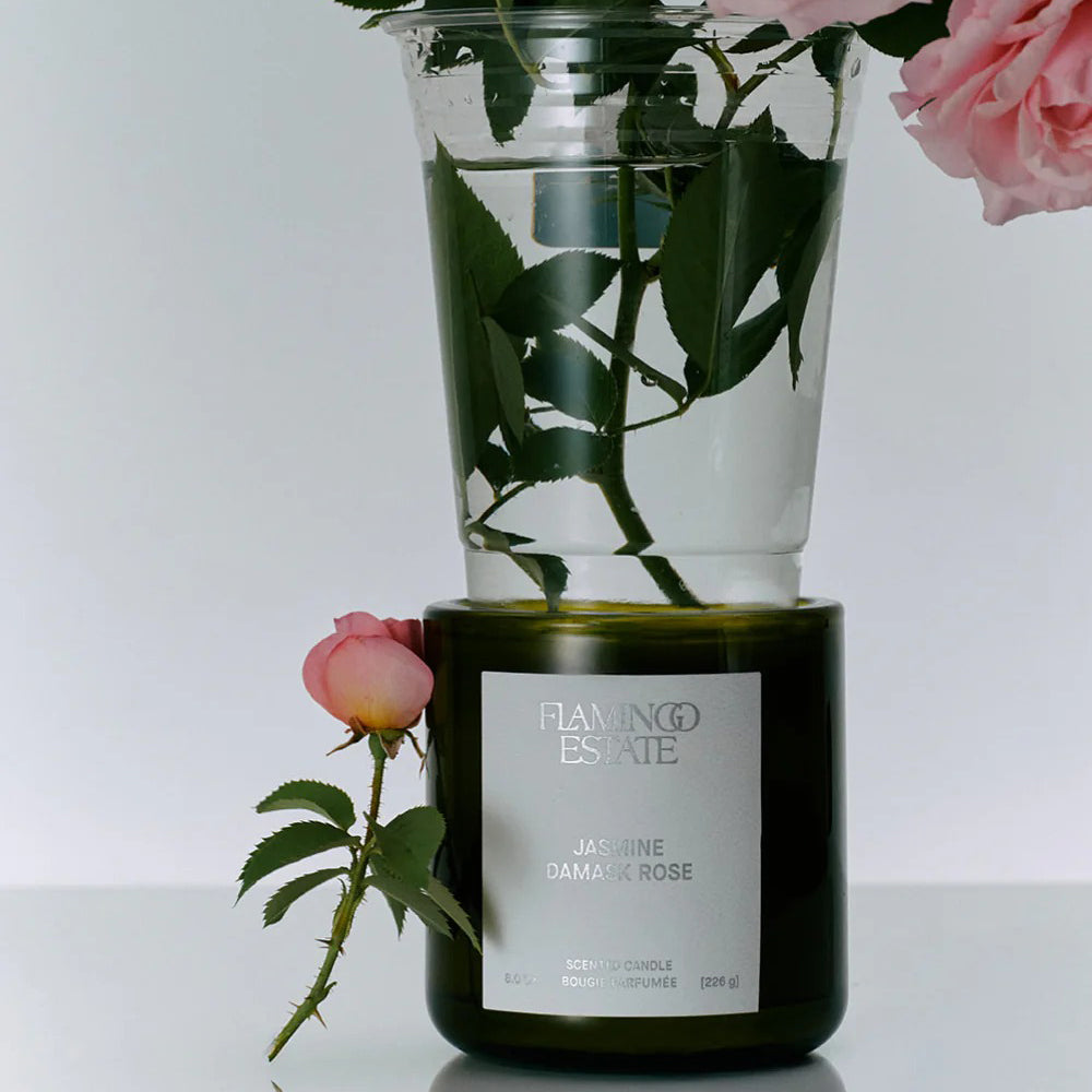 Flamingo estate Candle  and pink rose on a white background