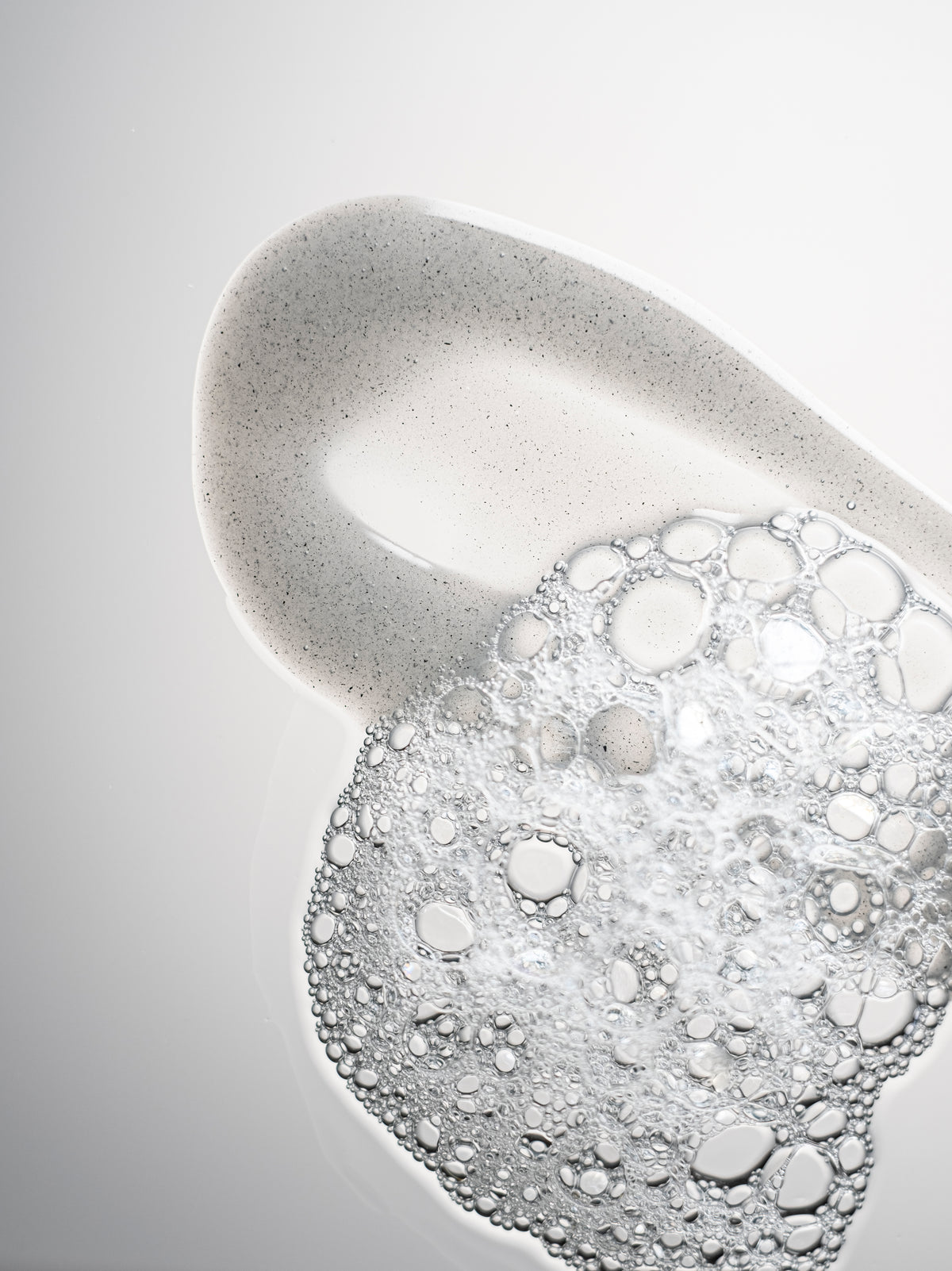 Close-up of Radford Clean - the only cleanser poured out and foamy, on a light gray background