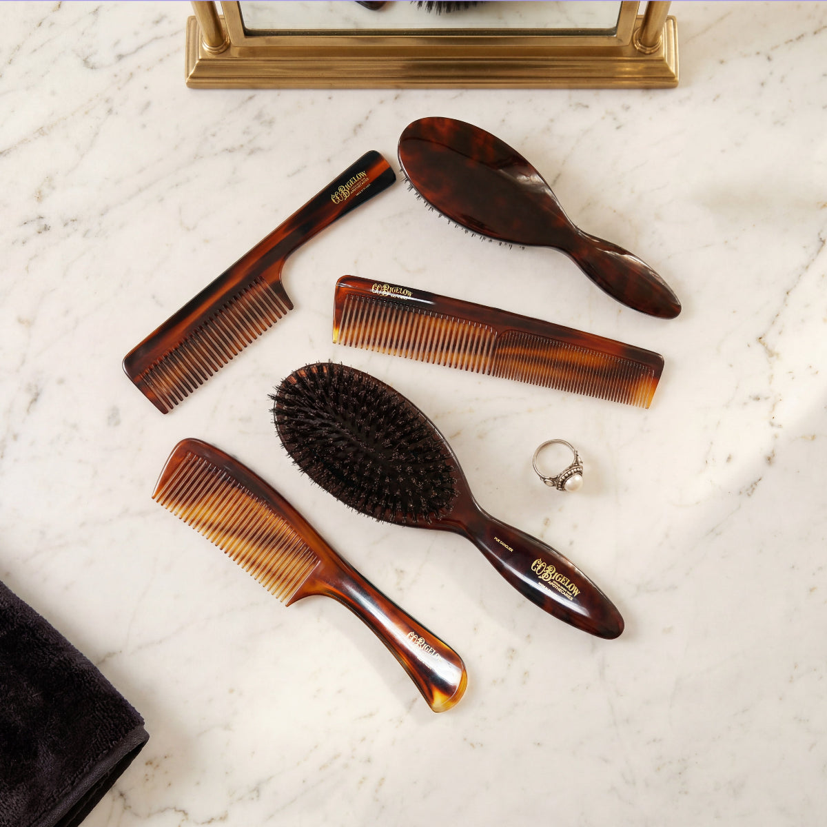 Bigelow Combs and Brushes on a granite surface.