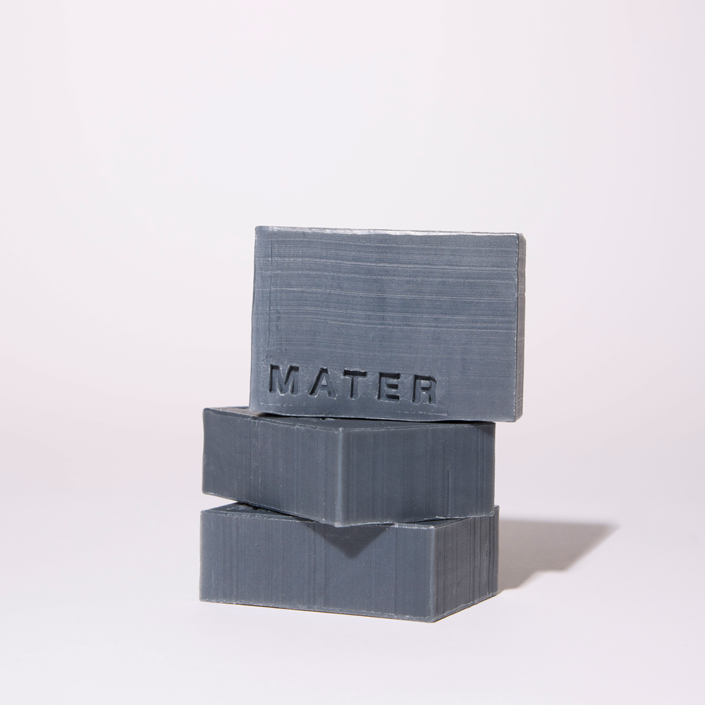 Three stacked rectangular bars of gray soap with a brushed texture and the brand name 'MATER' embossed on the top bar, set against a clean white background.