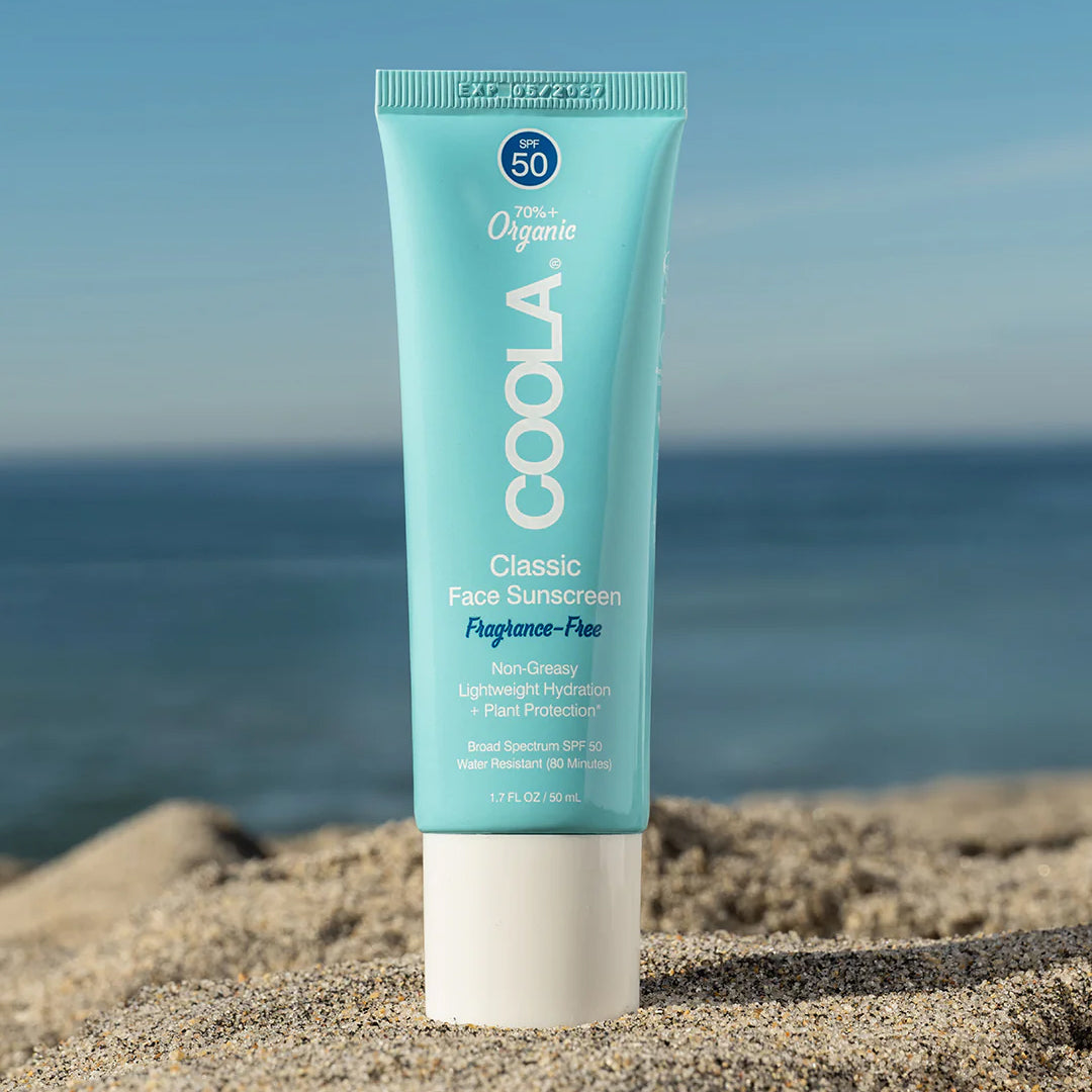 COOLA Classic Face Sunscreen product in a beach environment