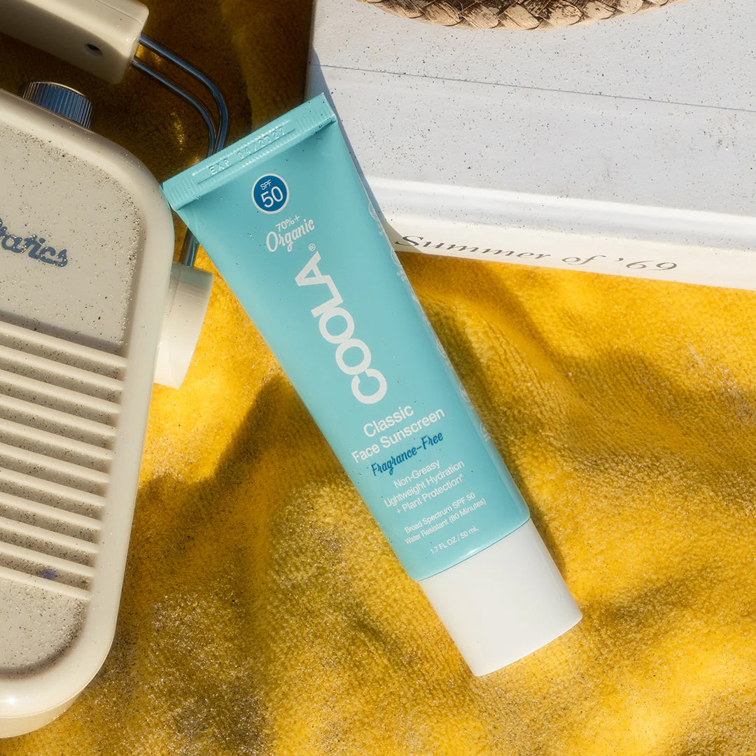 COOLA Classic Face Sunscreen product on a beach towel