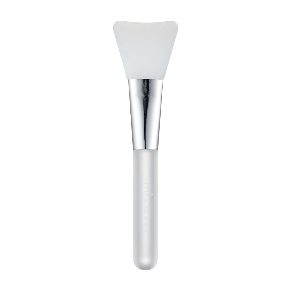 A cosmetic spatula brush with a white silicone bristle head, a shiny silver ferrule, and a frosted white handle, shown against a solid white background.