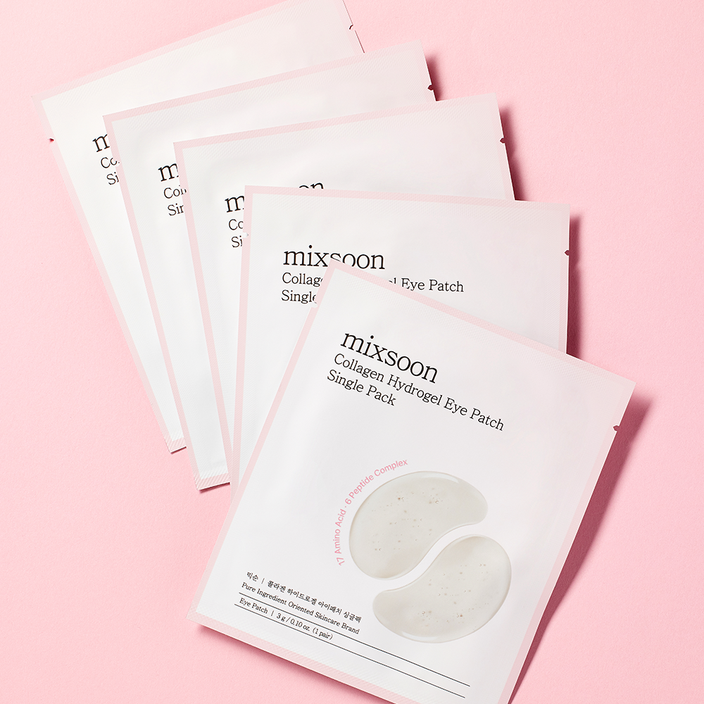 mixsoon Collagen Hydrogel Eye Patch Single Pack sachets laid out on a light pink background