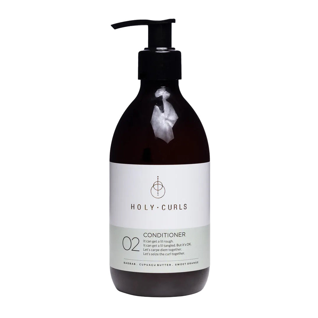 Bottle of Holy Curls conditioner on a white background