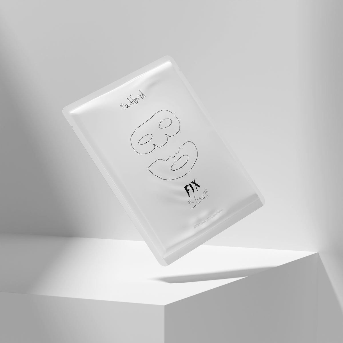 Pouch of Radford Fix -the face mask featuring minimalist black line drawings of a face mask and lips, floating above a white geometric pedestal in a clean, modern studio setting.