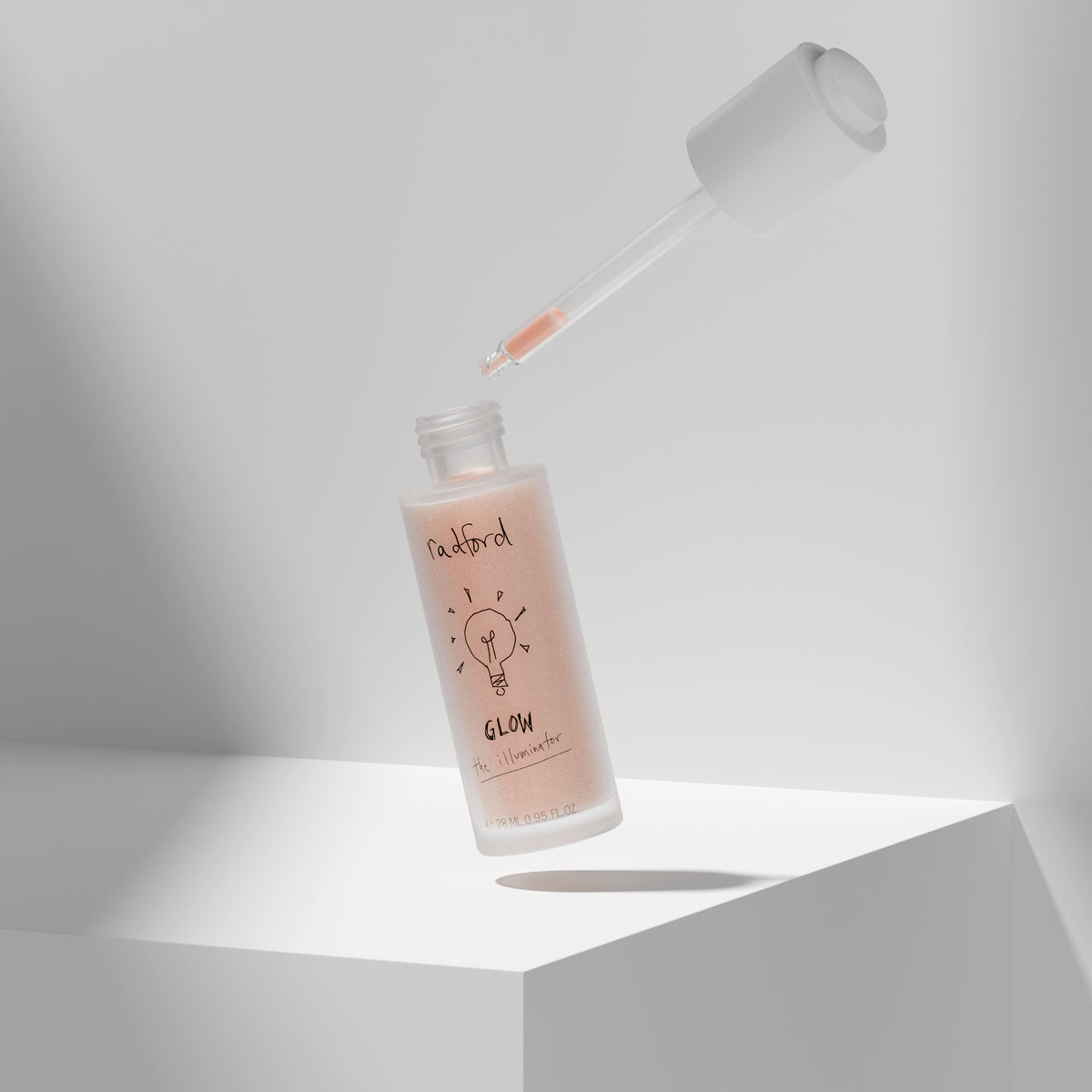 A frosted glass bottle Radford Glow the Illuminator with a floating dropper above it, set on a white geometric platform against a light gray background. 