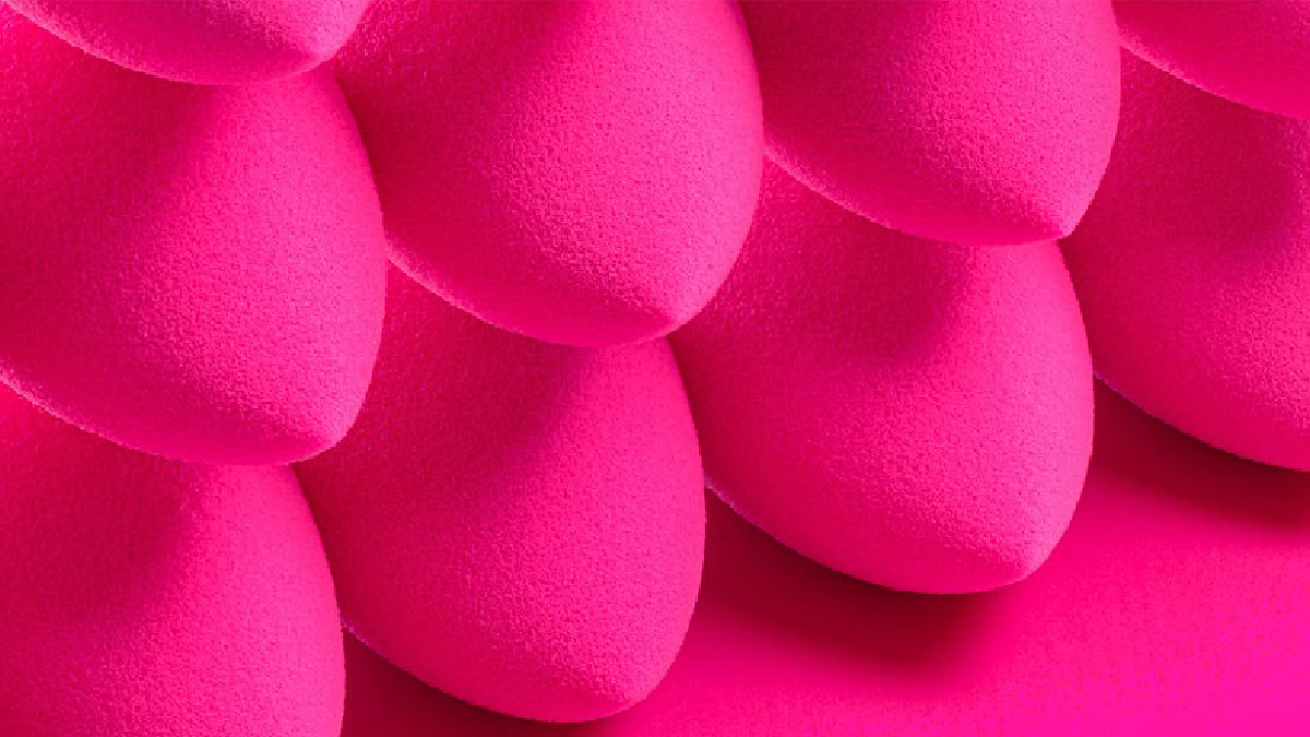 Close-up of pink makeup sponges on a pink background