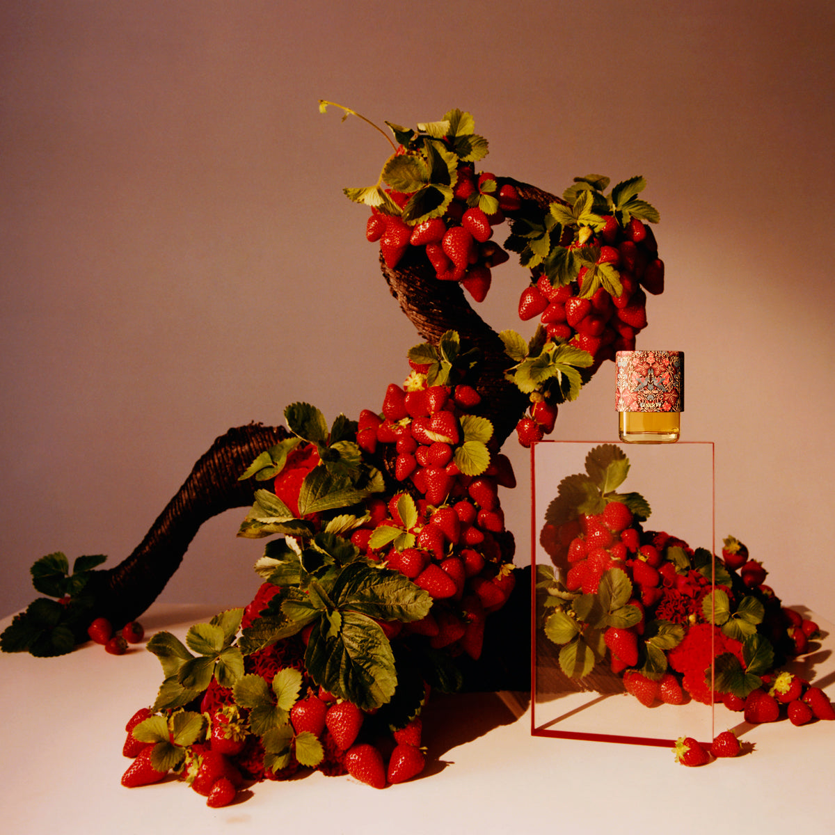 Decorative wreath with red berries and green leaves on a stand against a beige background