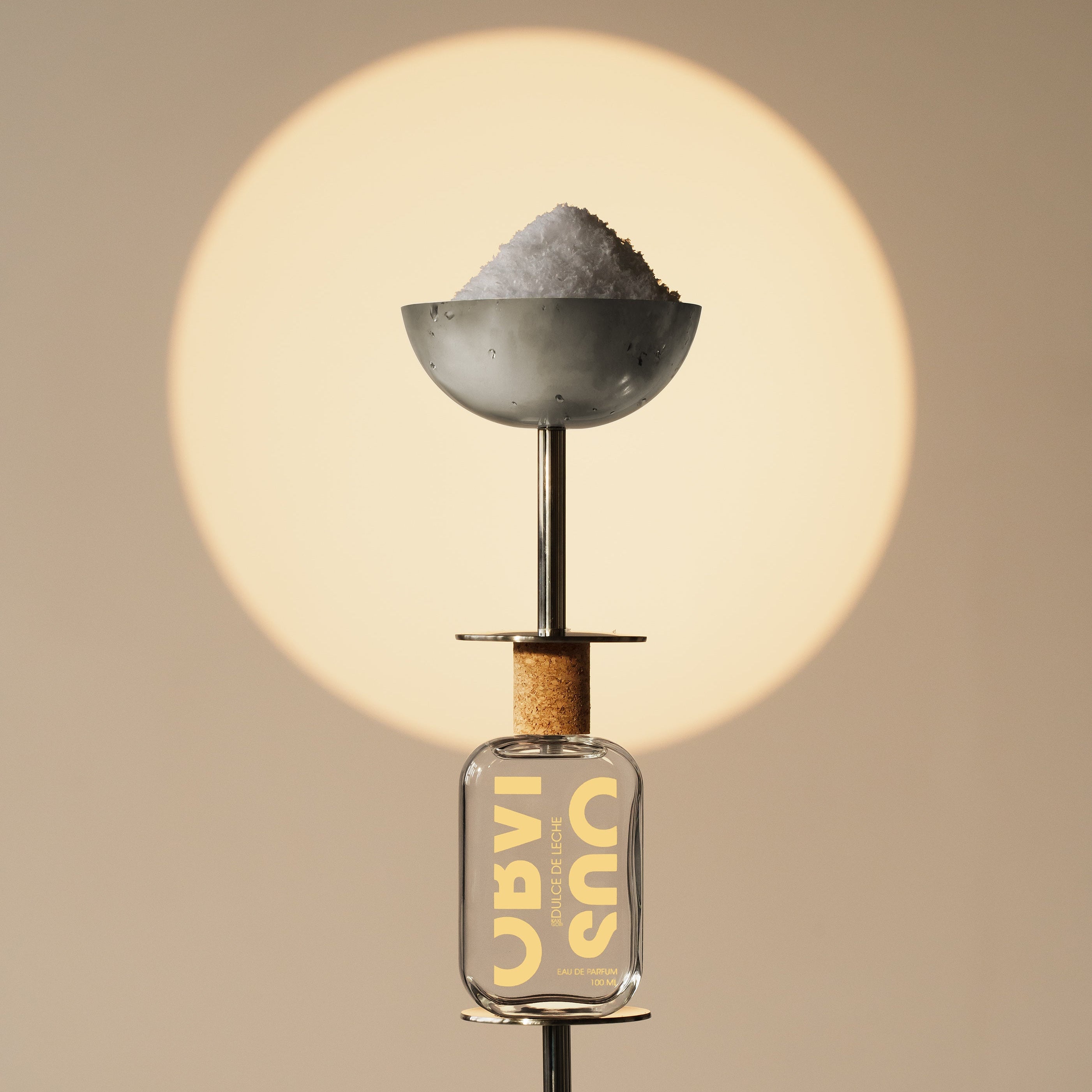 Perfume bottle stacked in between martini glasses