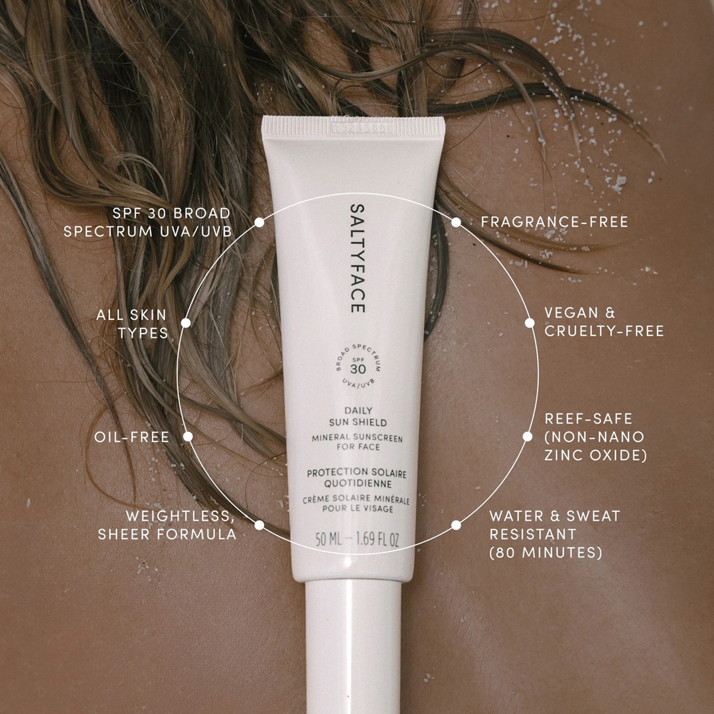 Salty Face sunscreen tube with product features highlighted on a brown background