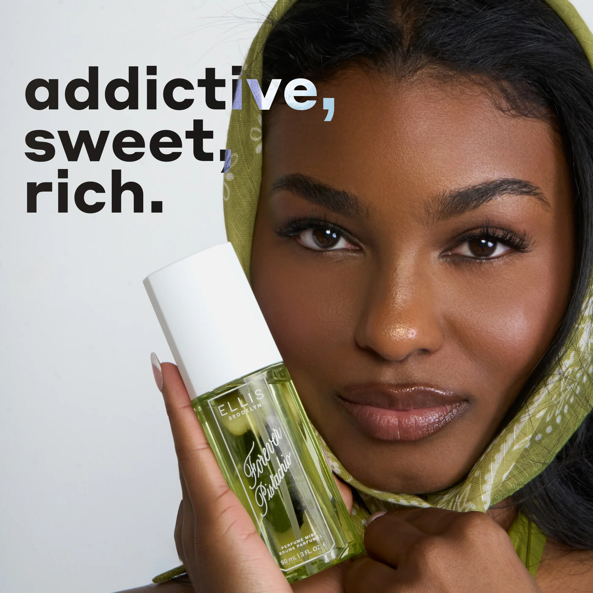 Woman holding a green bottle with text 'addictive, sweet, rich.'